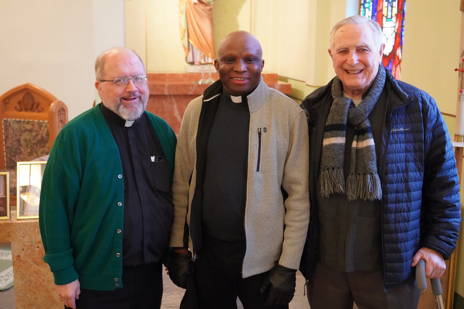 Father Robert Fields, pastor of St. Michael Parish in Kahoka and Shrine of St. Patrick Parish in St. Patrick; Father C. Callistus Okorojo, pastor of St. Joseph Parish in Canton and Queen of Peace Parish in Ewing; and Franciscan Father James Wheeler, of Quincy, Illinois, a St. Patrick native, stop for a photo during the Shrine of St. Patrick Parish’s feastday celebration.